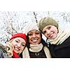 Group of three diverse young girl friends outdoors in winter