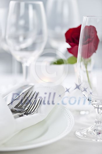 Romantic table setting with rose plates and cutlery Romantic table setting with rose plates and cutlery