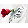 Romantic table setting with rose plates and cutlery