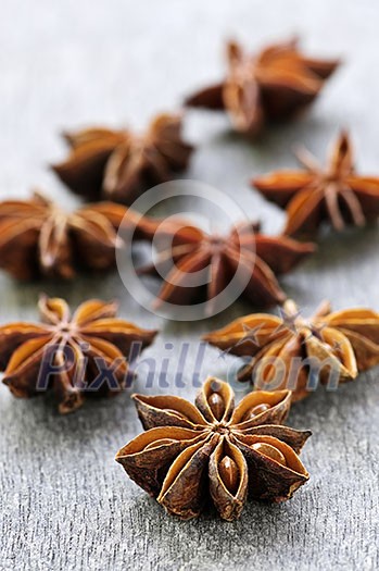 Dry star anise fruit and seeds on wooden background Dry star anise fruit and seeds on wooden background