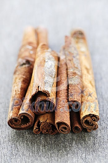Several cinnamon bark sticks on wooden background Several cinnamon bark sticks on wooden background