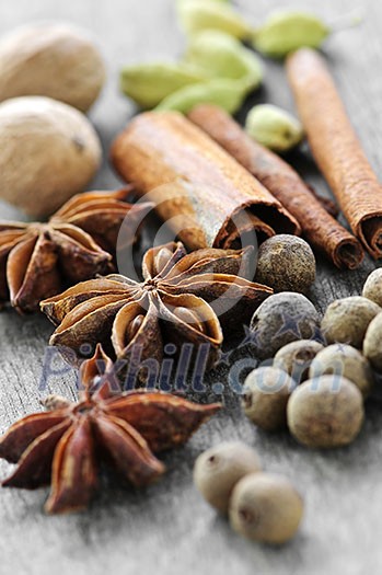 Assorted whole spices close up on wooden background Assorted whole spices close up on wooden background