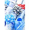 Rolls of Christmas wrapping paper with ribbons, bows and scissors