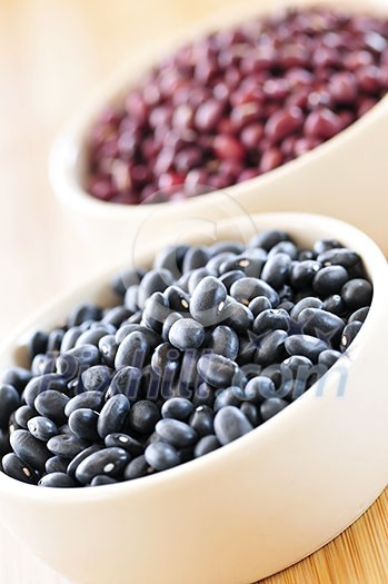 Dry black and red adzuki beans in bowls Dry black and red adzuki beans in bowls