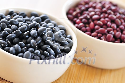 Dry black and red adzuki beans in bowls Dry black and red adzuki beans in bowls
