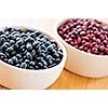 Dry black and red adzuki beans in bowls