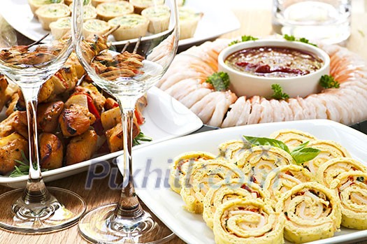 Many dishes of bite size appetizers and party food Many dishes of bite size appetizers and party food