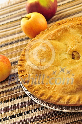 Whole apple pie with apples close up Whole apple pie with apples close up