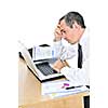 Stressed businessman sitting at his desk isolated on white background