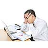 Stressed businessman sitting at his desk isolated on white background