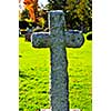 Bright graveyard lawn with ancient tombstone crosses