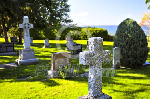 Bright graveyard lawn with ancient tombstone crosses Bright graveyard lawn with ancient tombstone crosses