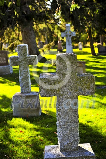 Bright graveyard lawn with ancient tombstone crosses Bright graveyard lawn with ancient tombstone crosses