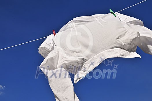 White shirt hanging to dry on clothes line White shirt hanging to dry on clothes line