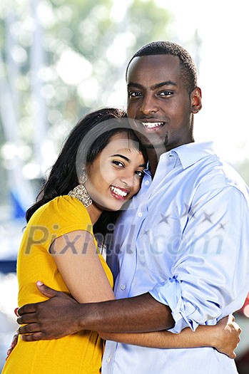 Young romantic couple hugging and standing at harbor Young romantic couple hugging and standing at harbor