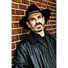 Man with beard in cowboy hat and leather jacket