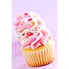 Row of tasty cupcakes with icing and sprinkles