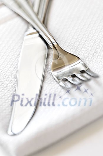 Fork and knife close up on white napkin Fork and knife close up on white napkin
