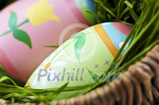 Easter eggs arrangement with green grass in a basket Easter eggs arrangement with green grass in a basket
