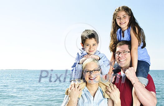 Happy family having fun giving shoulder rides Happy family having fun giving shoulder rides