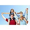 Happy family having fun giving shoulder rides