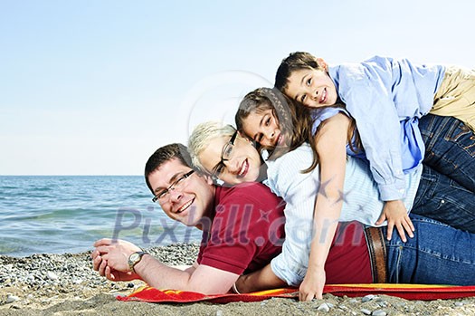 Portrait of a happy family having fun on a beach Portrait of a happy family having fun on a beach