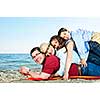 Portrait of a happy family having fun on a beach