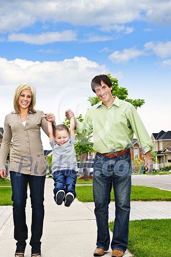 Young happy family playing with son on sidewalk Young happy family playing with son on sidewalk