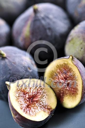 Closeup view of figs sliced in half on a blue plate Closeup view of figs sliced in half on a blue plate