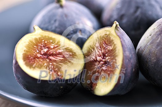 Closeup view of figs sliced in half on a blue plate Closeup view of figs sliced in half on a blue plate