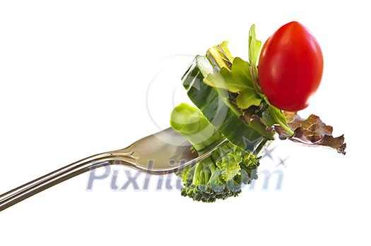 Fresh vegetables on a fork isolated on white background Fresh vegetables on a fork isolated on white background