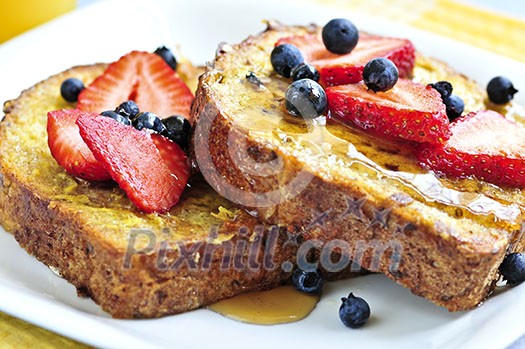 Breakfast of french toast with fresh berries and maple syrup Breakfast of french toast with fresh berries and maple syrup