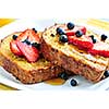 Breakfast of french toast with fresh berries and maple syrup
