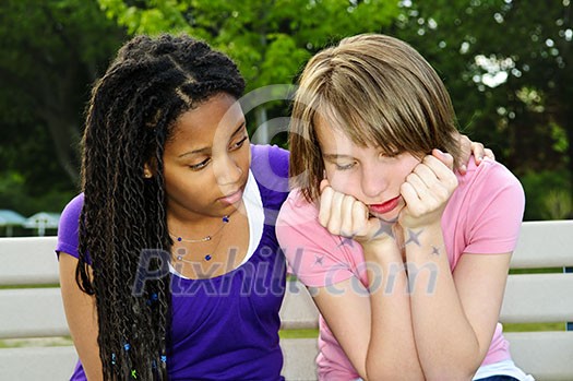 Teenage girl consoling her sad upset friend Teenage girl consoling her sad upset friend