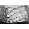 Close up on elderly woman hands with golden wedding ring