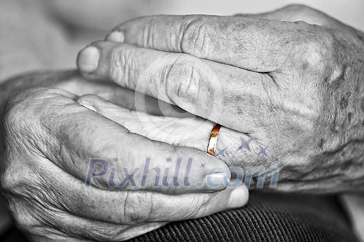 Close up on elderly woman hands with golden wedding ring Close up on elderly woman hands with golden wedding ring