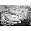 Close up on elderly woman hands with golden wedding ring
