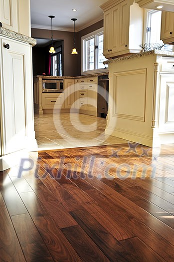 Hardwood and tile floor in residential home kitchen and dining room Hardwood and tile floor in residential home kitchen and dining room