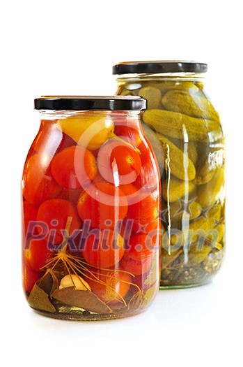 Two clear glass jars of colorful pickled vegetables Two clear glass jars of colorful pickled vegetables