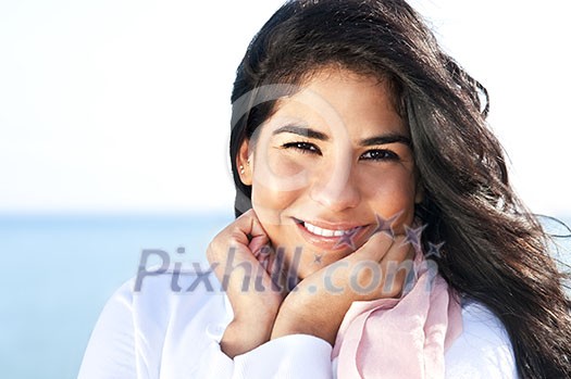 Portrait of beautiful smiling native american girl with hands at her face Portrait of beautiful smiling native american girl with hands at her face