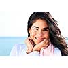 Portrait of beautiful smiling native american girl with hands at her face
