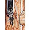 Set of keys in lock of old wooden door