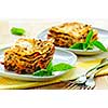Two servings of fresh baked lasagna on plates