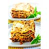 Two servings of fresh baked lasagna on plates
