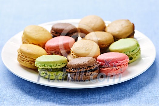 Fresh multicolored macaroon cookies served on a plate Fresh multicolored macaroon cookies served on a plate