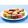 Fresh multicolored macaroon cookies served on a plate
