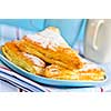 Apple turnovers pastries with coffee cups in the background