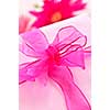 Gift box wrapped in pink paper with ribbon and bow
