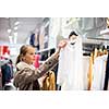 Young woman shopping in a fashion store (color toned image; shallow DOF)