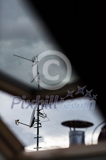 Antennas and a satellite dish on a roof Antennas and a satellite dish on a roof